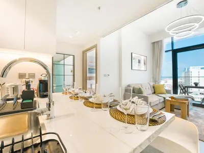 a kitchen and living room with white walls and windows at EasyGo- Splendid Apartments in Al Meydan Living in Dubai