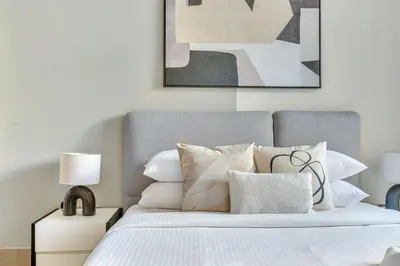 a bedroom with a bed with white sheets and pillows at GuestReady - Downtown oasis with Burj Khalifa view in Dubai