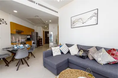 a living room with a blue couch and a table at Burj Khalifa View - 1BR in Bellevue Tower 2, Downtown - Allsopp & Allsopp in Dubai