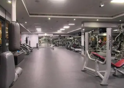 a gym with rows of treadms and machines at HAVN - Studio Apartment in Goldcrest Views, JLT in Dubai