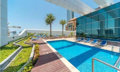 a swimming pool on the roof of a building at HAVN - Studio Apartment in Goldcrest Views, JLT in Dubai