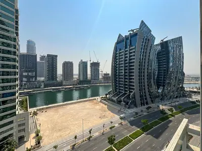 a view of a city with a river and buildings at Keyrock Living - 1BR at Reva Residence with Lake View in Dubai