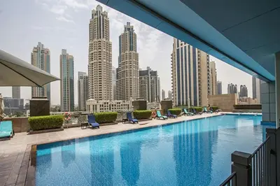 a large swimming pool with a view of a city at HAVN - Studio in 8 Boulevard, Downtown Dubai in Dubai