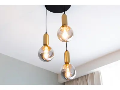 a group of three lights hanging from a ceiling at Luxury 1-Bedroom Apartment with Pool, Gym & Balcony in Business Bay in Dubai