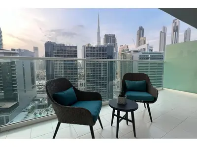 two chairs on a balcony with a view of the city at Luxury 1-Bedroom Apartment with Pool, Gym & Balcony in Business Bay in Dubai
