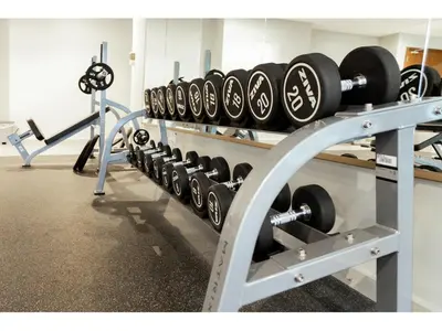 a row of dumbbells on a rack in a gym at Luxury 1-Bedroom Apartment with Pool, Gym & Balcony in Business Bay in Dubai
