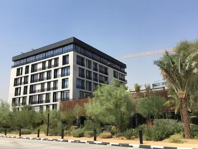 a tall building with a crane in the background at HAVN - Studio in KOA Canvas, Access to Nasab Dubai in Dubai