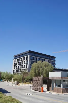 a large building in front of a parking lot at HAVN - Studio in KOA Canvas, Access to Nasab Dubai in Dubai