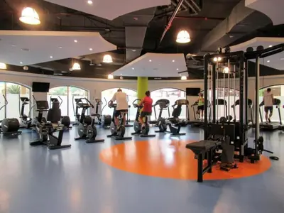 a gym with several tread machines and people in it at HAVN - Studio in Murjan JBR, 5mins to JBR Beach in Dubai