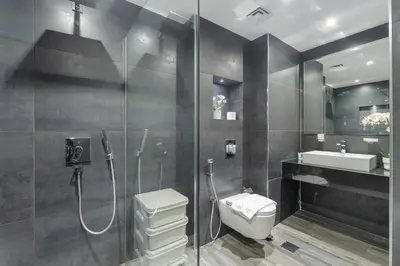 a bathroom with a shower and a toilet and a sink at HAVN - Studio in Murjan JBR, 5mins to JBR Beach in Dubai