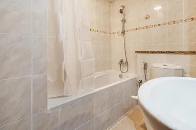 a bathroom with a tub and a toilet and a sink at Stylish JLT Studio Lakeview Metro FrontMarina in Dubai