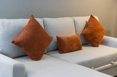 four pillows sitting on a white couch at Stylish JLT Studio Lakeview Metro FrontMarina in Dubai