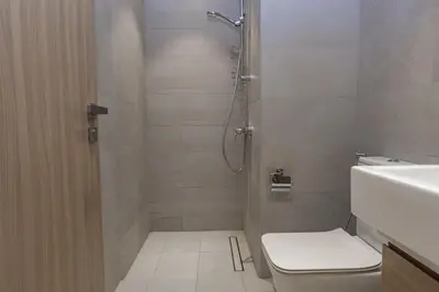 a bathroom with a shower with a toilet and a sink at Bloomfields Modern 2br Azizi Gardens in Dubai