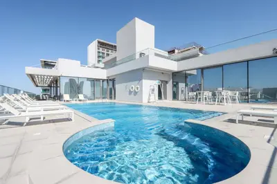 a swimming pool in the middle of a house at Livbnb-Perfect 1BR Retreat in the Heart of JVC in Dubai
