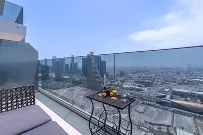 a balcony with a table and a view of a city at Vogue Al Wasl 1 Residences Near Zabeel Park and World Trade Centre, One Bedroom Apartment with Balcony and City View, Access to all Amenities, Walkable to Max Fashion Metro Station in Dubai