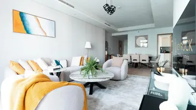 a living room with a couch and chairs and a table at 3BR Paramount Downtown - Burj Khalifa View in Dubai