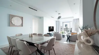 a dining room with a table and chairs at 3BR Paramount Downtown - Burj Khalifa View in Dubai