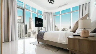 a bedroom with a large bed and a large window at 3BR Paramount Downtown - Burj Khalifa View in Dubai