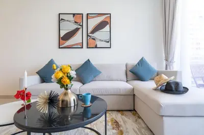 a living room with a couch and a table at Vogue Al Wasl 1 Residences Near Zabeel Park and World Trade Centre, Two Bedroom Apartment with Balcony offering Dubai Frame and City View, Access to all Amenities, Walkable to Max Fashion Metro Station in Dubai
