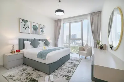 a bedroom with a bed and a mirror and a chair at Vogue Al Wasl 1 Residences Near Zabeel Park and World Trade Centre, Two Bedroom Apartment with Balcony offering Dubai Frame and City View, Access to all Amenities, Walkable to Max Fashion Metro Station in Dubai