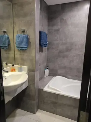 a bathroom with a tub and a sink and a bath tub at Studio in Business bay, Metro! in Dubai