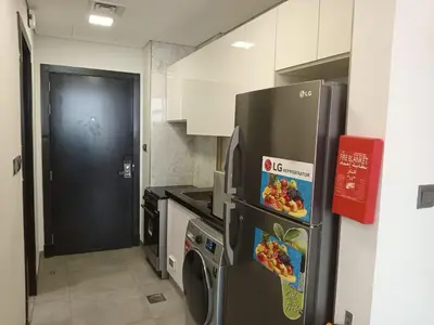 a kitchen with a refrigerator and a washing machine at Studio in Business bay, Metro! in Dubai