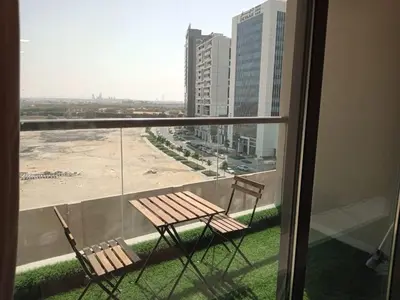 two chairs sitting on the balcony of a building at Studio in Business bay, Metro! in Dubai