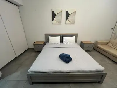 a bedroom with a bed with a blue robe on it at Studio in Business bay, Metro! in Dubai