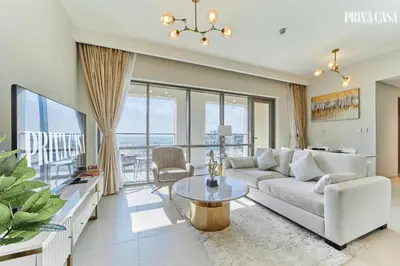 a living room with a couch and a table at PRIVA CASA - Luxurious 2BR Vida Creek Beach - Beach access in Dubai