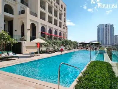 a swimming pool in front of a building at PRIVA CASA - Luxurious 2BR Vida Creek Beach - Beach access in Dubai