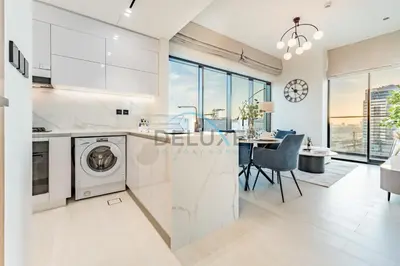 a kitchen with a washer and dryer in a apartment at City Views 1BR Close to Golf Course & Attractions, Binghatti Venus, Jumeirah Village Circle by Deluxe Holiday Homes in Dubai