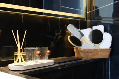 a counter with a basket of utensils on a shelf at Cosy Studio in Binghatti House in Dubai