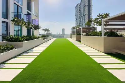 a green lawn in the middle of a building at Stunning Studio in Binghatti House in Dubai