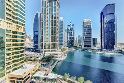 a river in a city with tall buildings at Waves - Modern Studio with Stunning Lake Views in JLT in Dubai