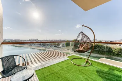 a room with a balcony with a swing at Starfish Palm Views Studio in Dubai