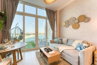 a living room with a couch and a table at Octopus - Iconic Palm Studio With Views in Dubai