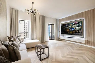 a living room with a couch and a tv at Daniels 1BR at Sadaf JBR in Dubai