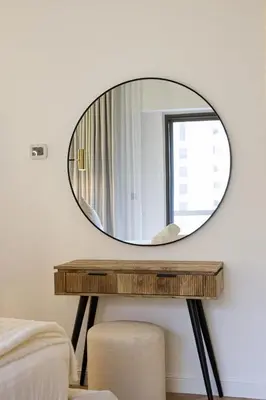 a round mirror on a table in a bedroom at Daniels 1BR at Sadaf JBR in Dubai