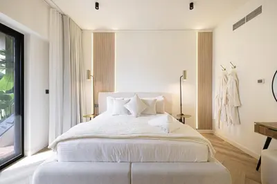 a bedroom with a large white bed with white pillows at Daniels 1BR at Sadaf JBR in Dubai