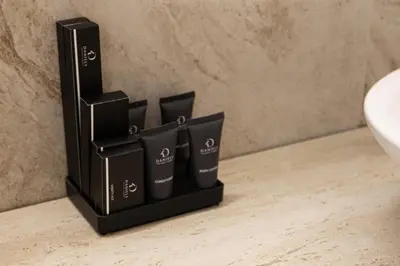 a black container sitting on a bathroom counter next to a sink at Daniels 1BR at Sadaf JBR in Dubai