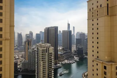 a view of a city with a river and buildings at Daniels 1BR at Sadaf JBR in Dubai