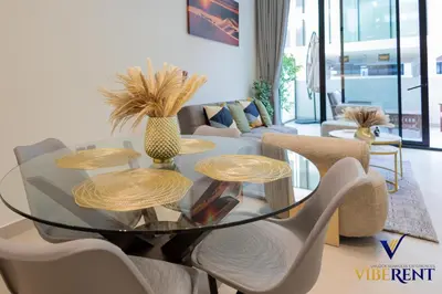 a living room with a glass table and chairs at 1-BR Binghatti Rooftop Pool, Gym in Dubai