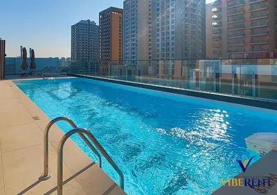 a large swimming pool on top of a building at 1-BR Binghatti Rooftop Pool, Gym in Dubai