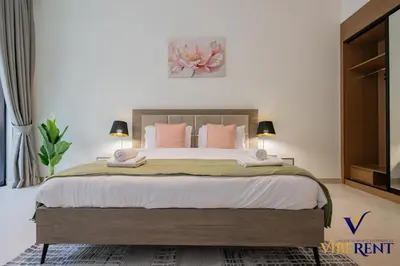 a bedroom with a large bed with pink pillows at 1-BR Binghatti Rooftop Pool, Gym in Dubai