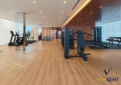 a gym with treadmills and exercise equipment in a building at 1-BR Binghatti Rooftop Pool, Gym in Dubai
