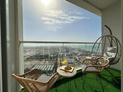 a balcony with a table and two chairs and a view at Luxueux Ammenities Tower, Sea View, Near to Beach in Dubai