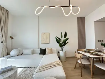 a white living room with a couch and a table at Luxueux Ammenities Tower, Sea View, Near to Beach in Dubai