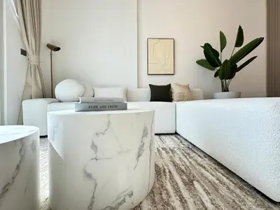 a living room with a white couch and a marble table at Luxueux Ammenities Tower, Sea View, Near to Beach in Dubai
