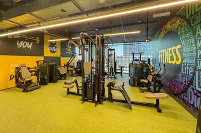 a gym with several tread machines in a room at High End 1 Bedroom with Exquisite Layout in JLT in Dubai