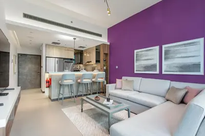 a living room with a couch and a kitchen at High End 1 Bedroom with Exquisite Layout in JLT in Dubai